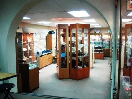 Interior view of a jewelry store with display cases filled with items.