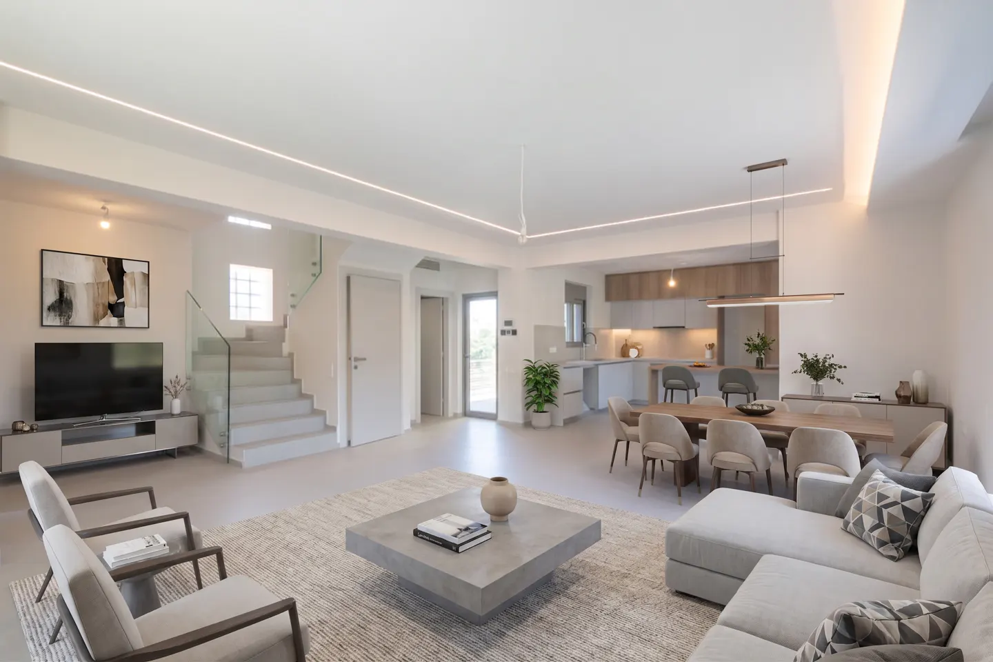 Modern open-plan living area with a light gray sofa, armchairs, concrete coffee table, dining set, and staircase.