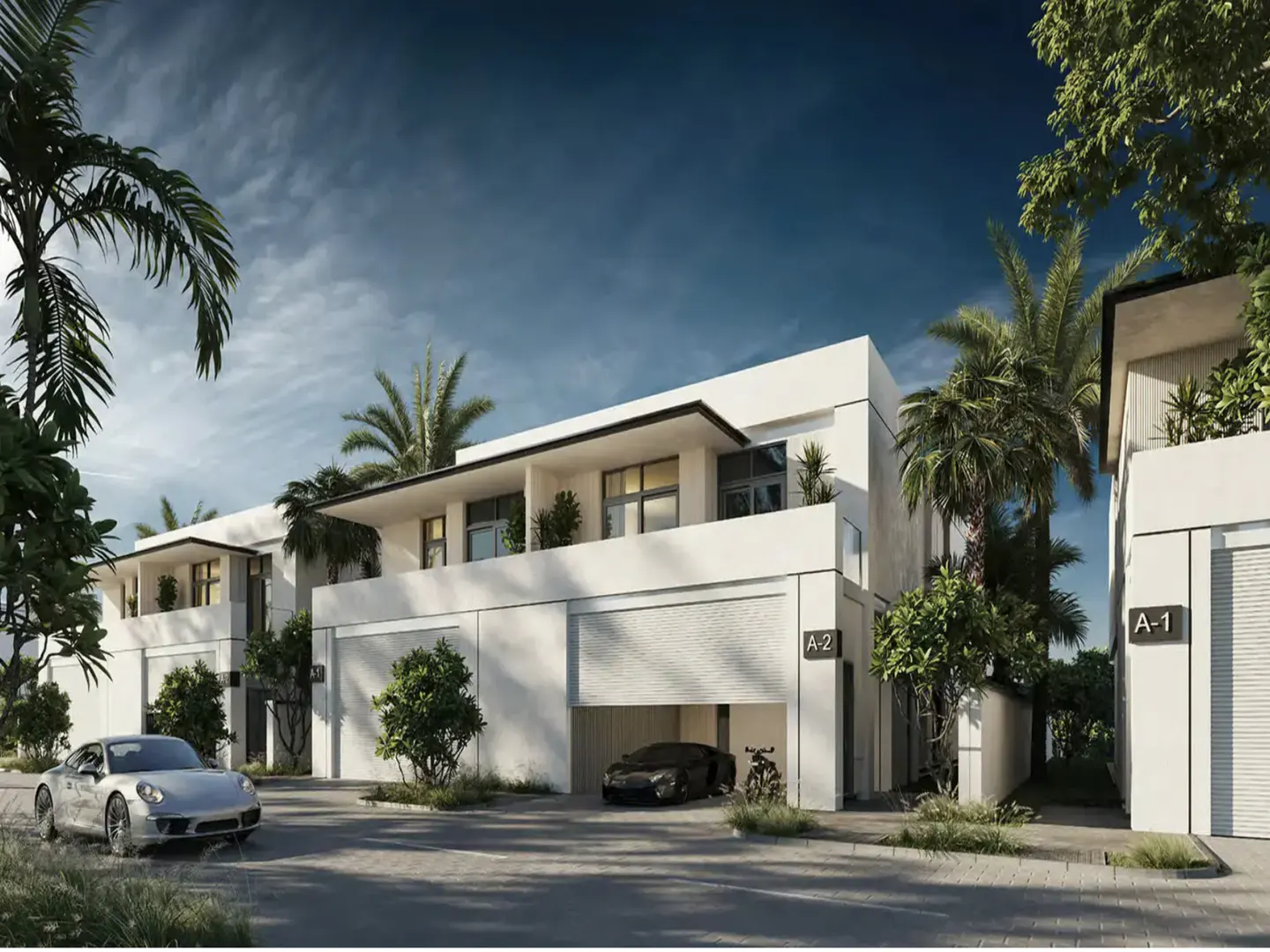 Modern white townhouses with palm trees. A silver Porsche is parked in front, and a black car is in the open garage of unit A-2.