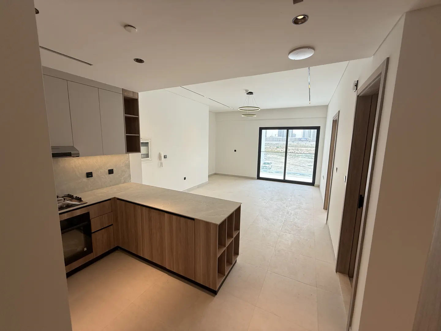 Open kitchen and living room area with balcony access