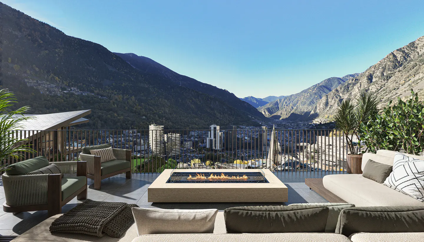 Outdoor patio with a fire pit, chairs, and a sofa overlooking a mountain range and city.