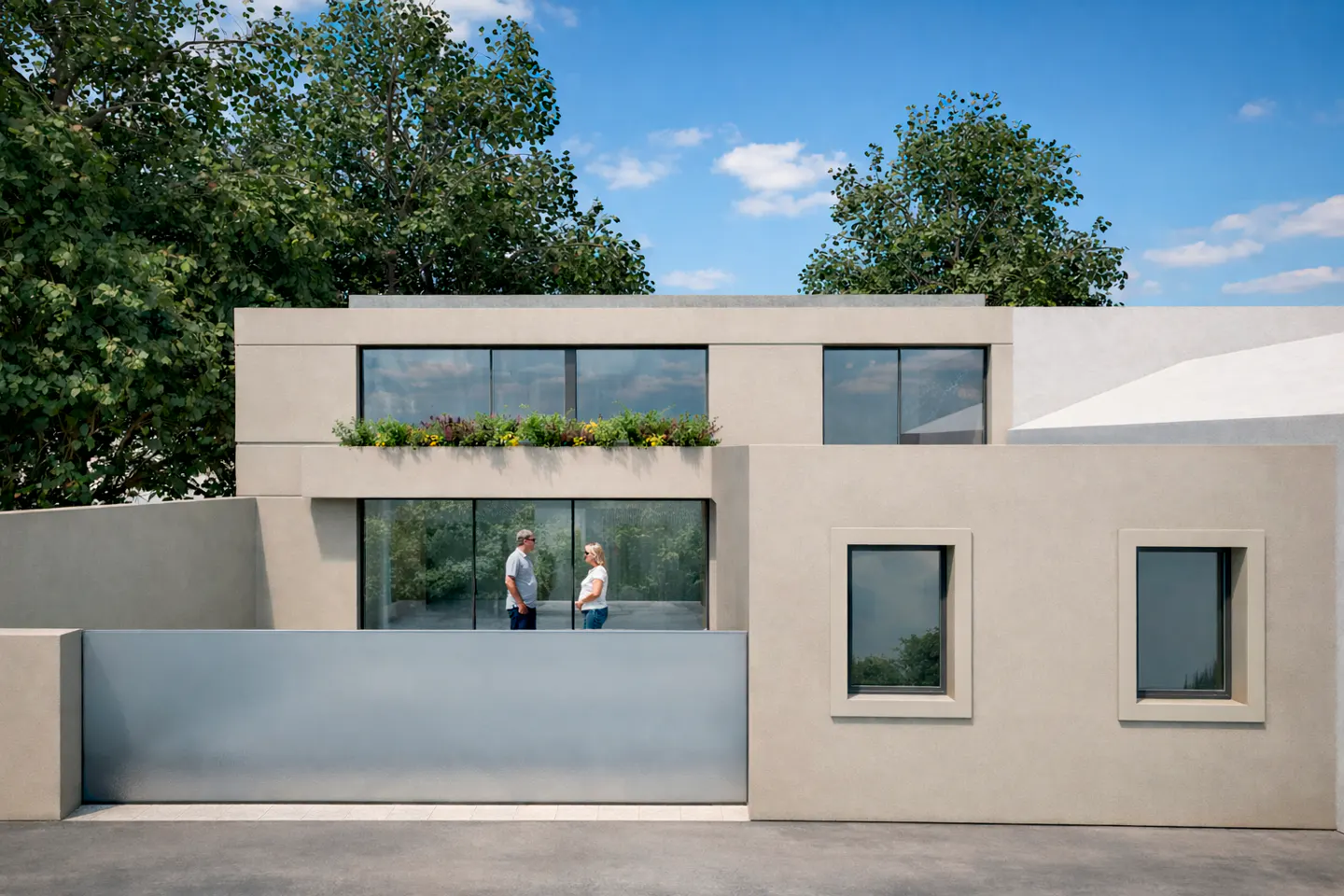 Modern beige house with large windows and a gray gate. A man and woman stand inside. Green trees and blue sky in the background.