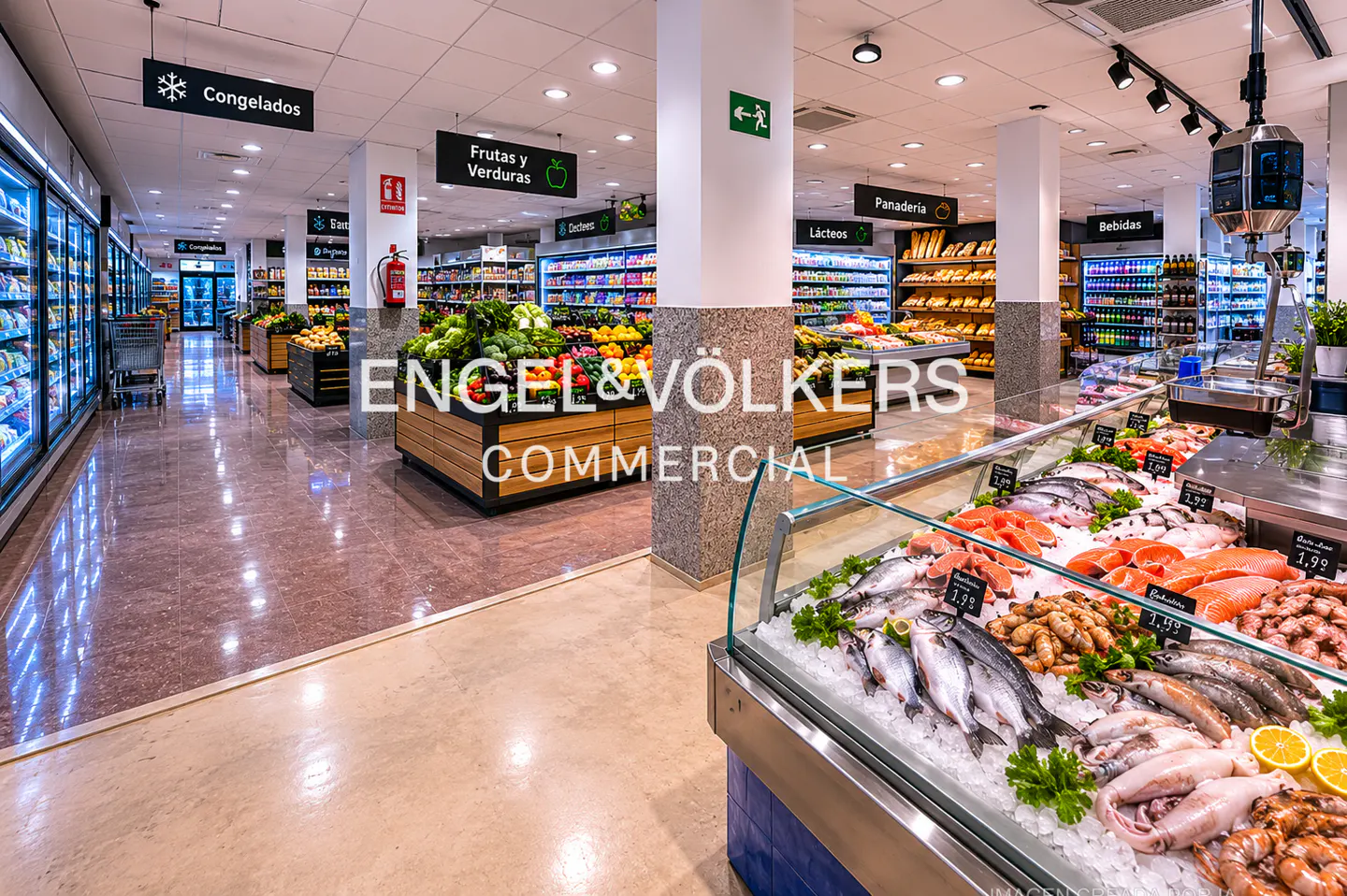Aisles of a bright supermarket with produce, frozen foods, bakery, and seafood sections. Overhead signs in Spanish.