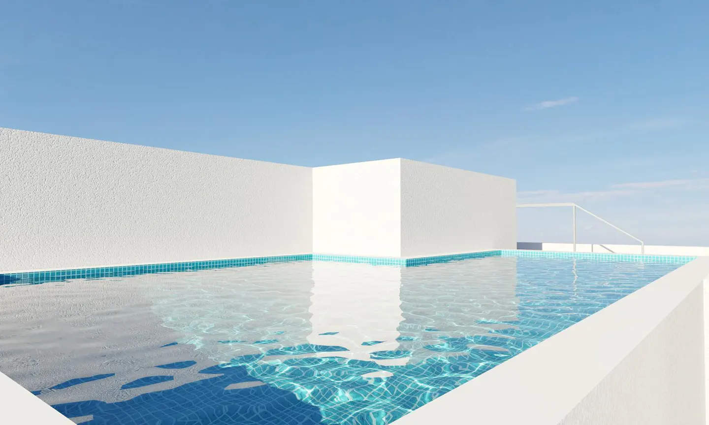 A rooftop pool with blue water and white walls under a clear blue sky.