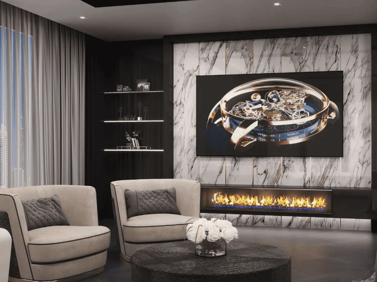Living room with beige armchairs, a black coffee table with white flowers, and a marble wall with a TV above a fireplace.