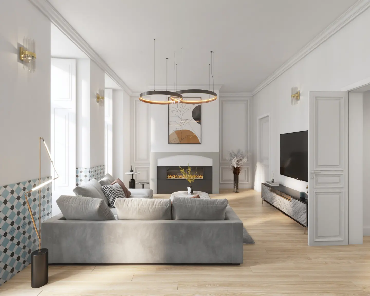 Bright living room with a gray sofa, fireplace, TV, and wood floors. Circular pendant lights hang from the ceiling.