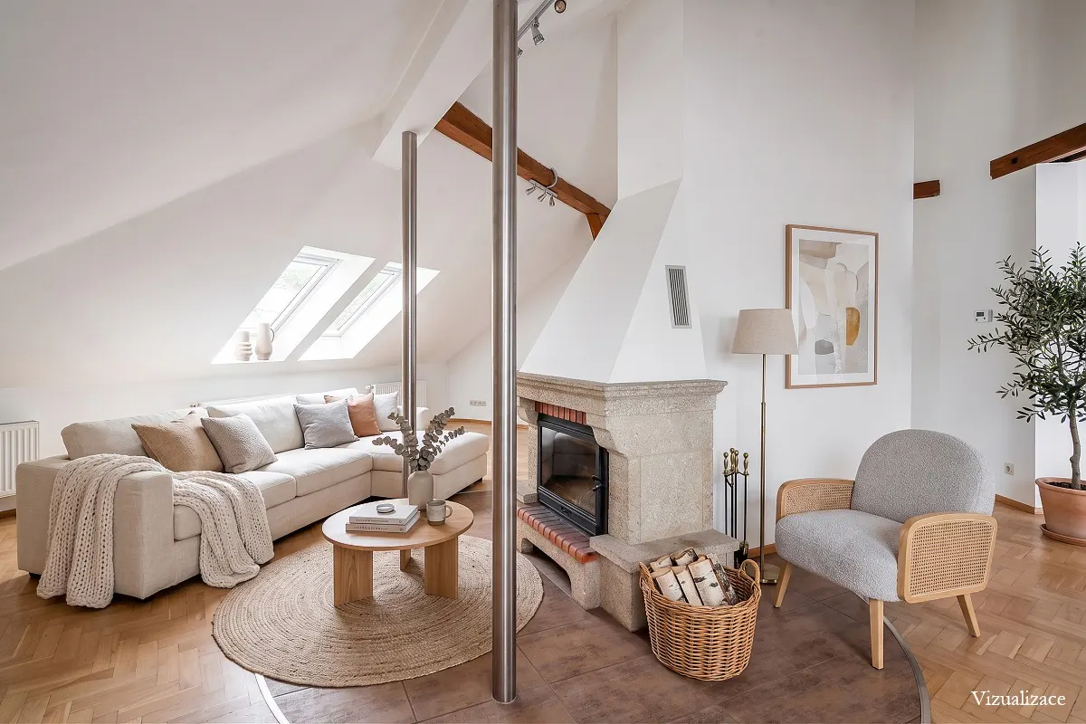 Bright living room with a stone fireplace, a white sofa, a round wooden table on a jute rug, and a gray armchair.