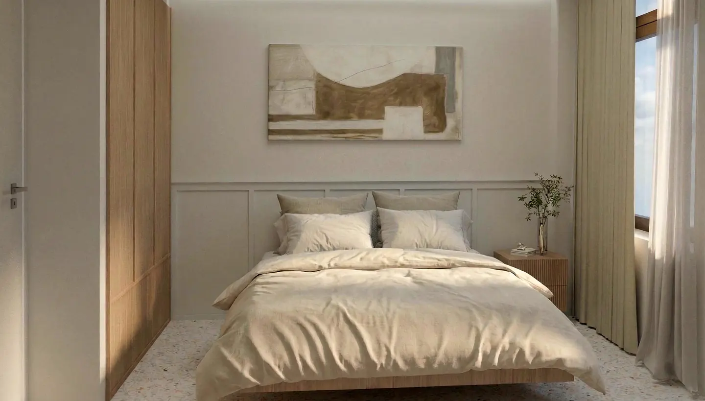 Beige bedroom with a bed, abstract art, and a window with sheer curtains. A wooden wardrobe stands to the left.