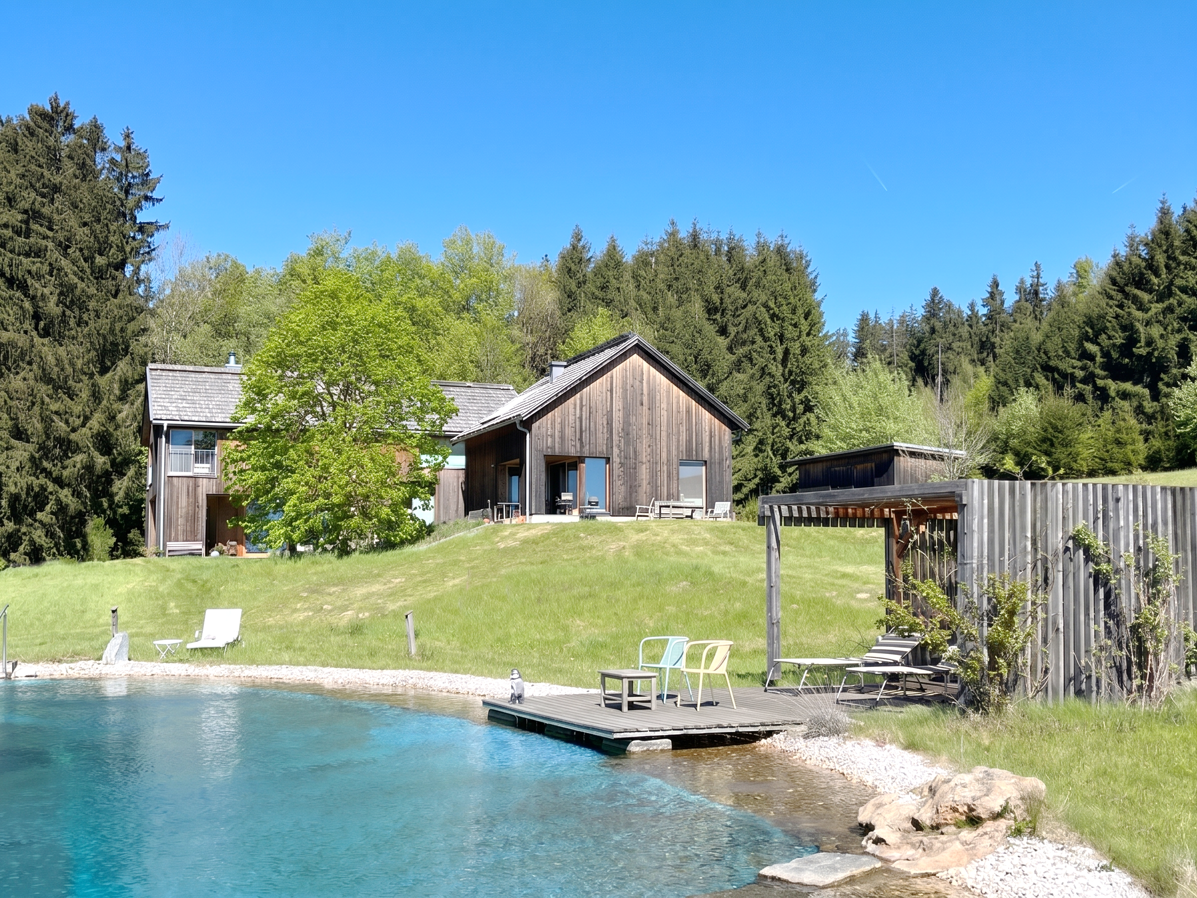 Exceptional timber-built single-family home with swimming pond in a perfectly quiet location
