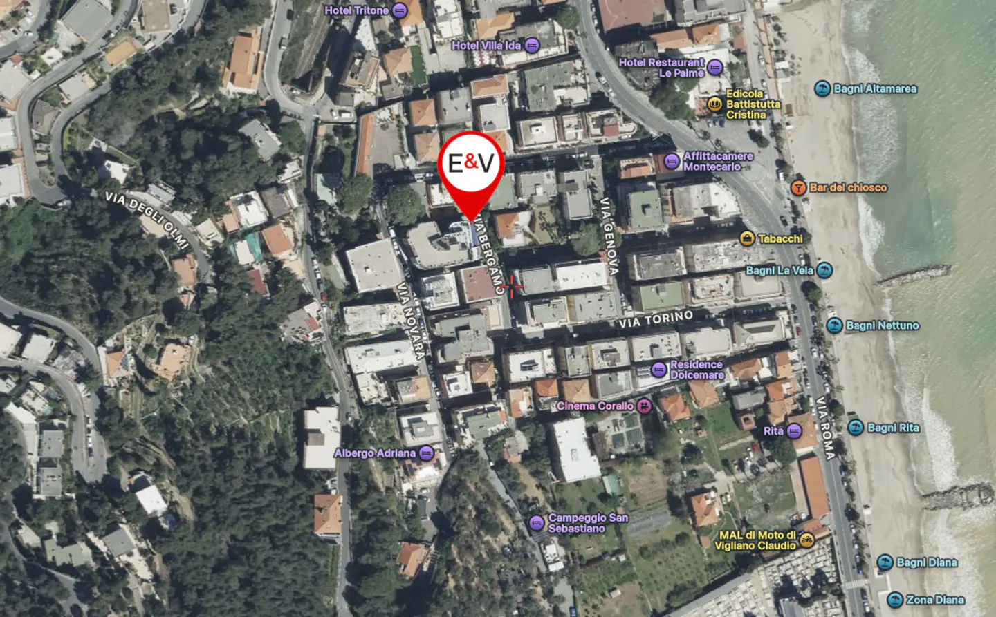 Aerial view of a coastal town with a red pin labeled "E&V" marking a building on Via Bergamo. The sea is visible to the east.