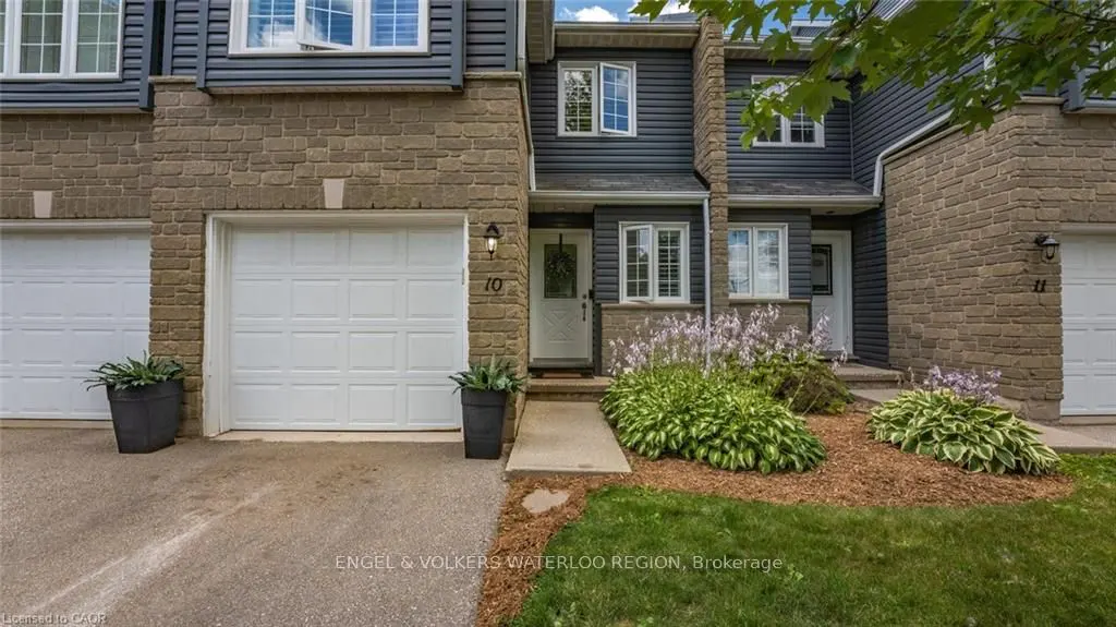 Exterior view of a two-story townhouse with a white garage door and a white front door with number 10 above it.