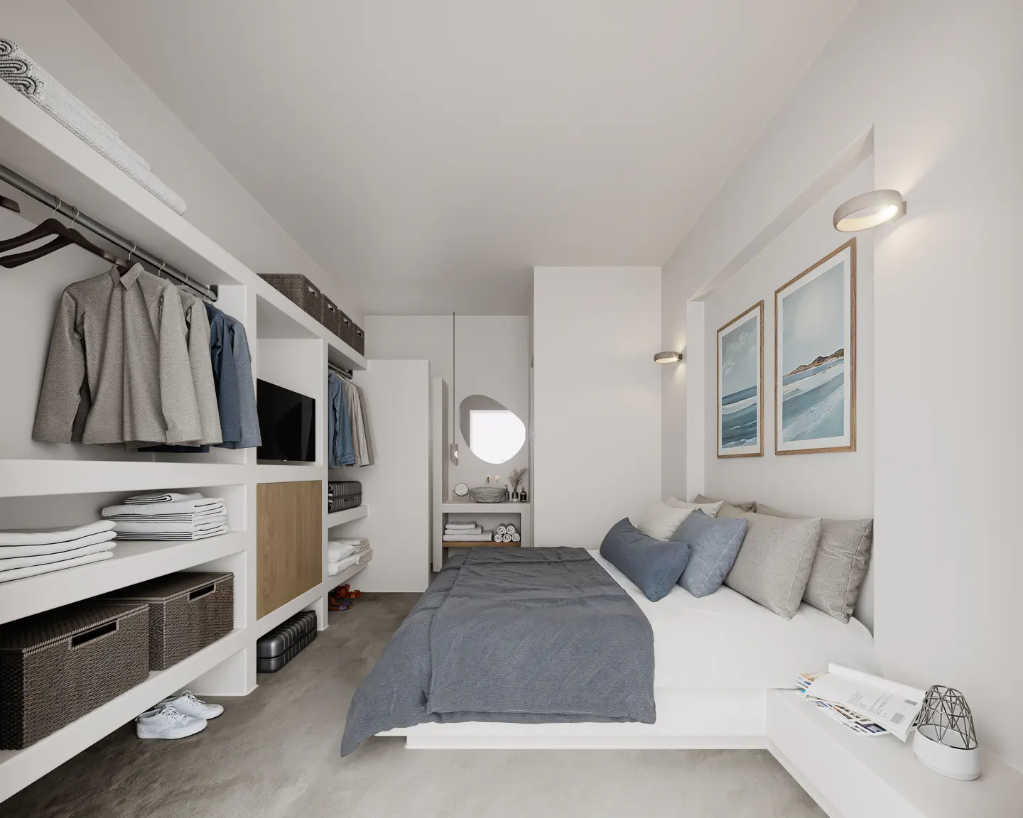 Bright bedroom with a gray bedspread, blue pillows, and white walls. A closet with clothes and shelves is on the left. Two framed pictures hang on the wall.