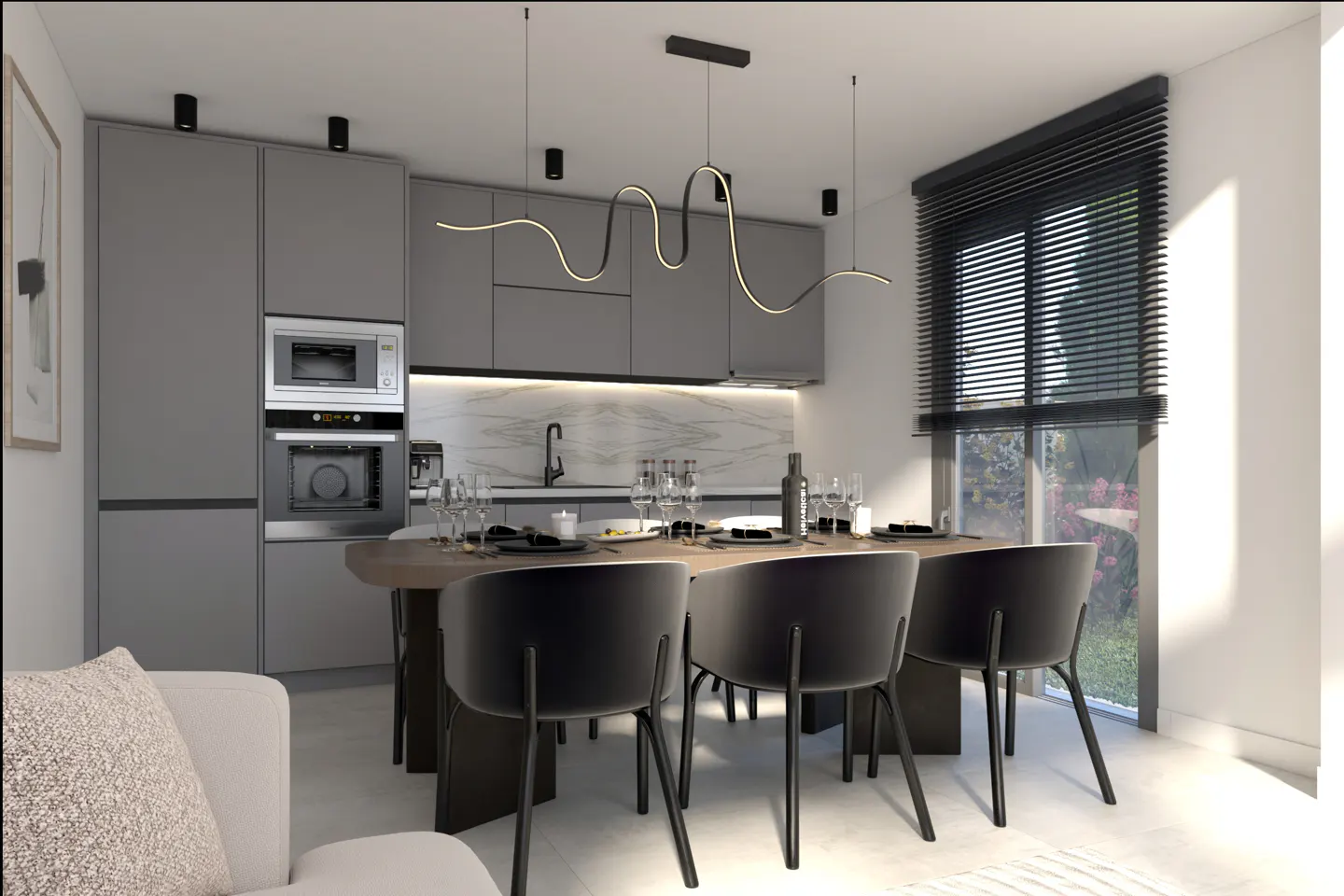 Modern kitchen and dining area with gray cabinets, wood table, black chairs, and a unique wavy light fixture. Window with blinds lets in natural light.