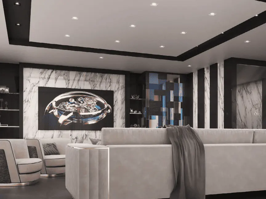 Modern living room with white sofas, marble walls, and a large watch art piece. Recessed lighting illuminates the space.