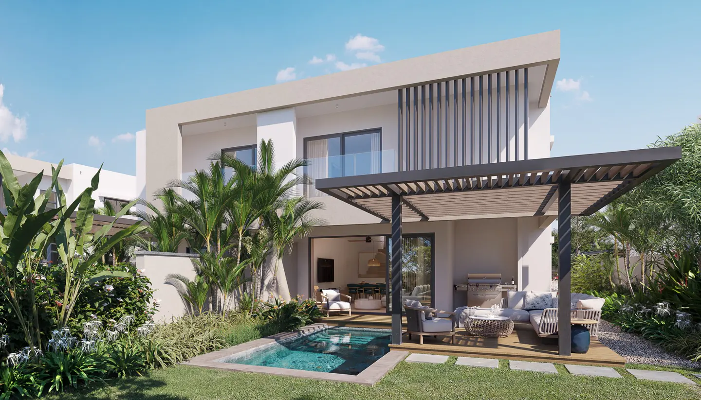 Modern two-story home with a small pool, patio furniture under a pergola, and lush tropical landscaping on a sunny day.