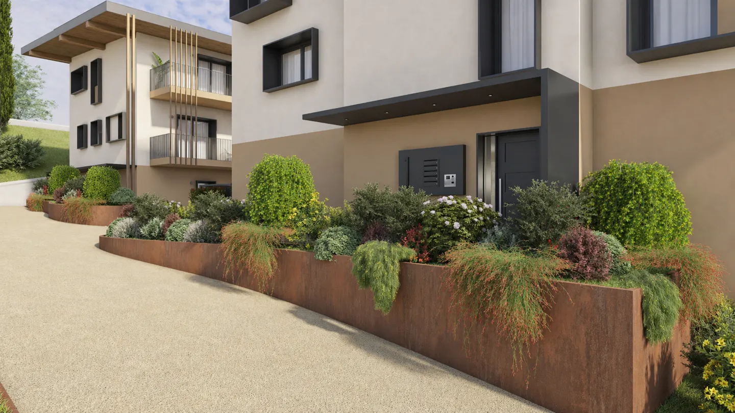 Modern building exterior with a rusty metal planter filled with green plants and shrubs. Tan gravel driveway.