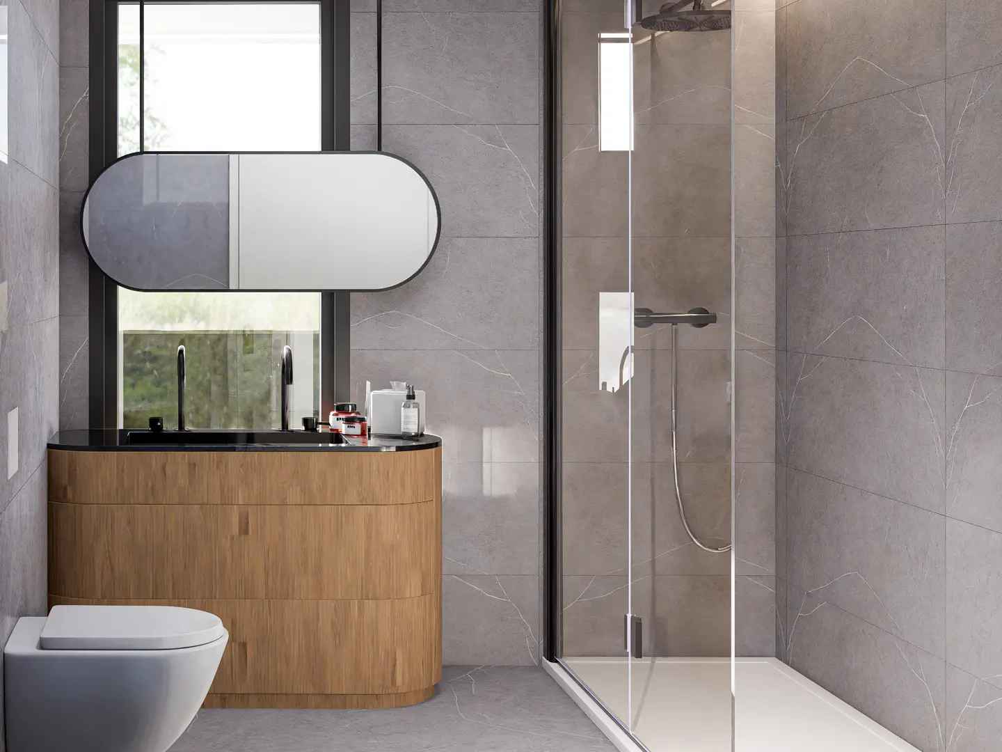 Modern bathroom with gray tile walls, a wood vanity with black countertop, and a glass-enclosed shower.