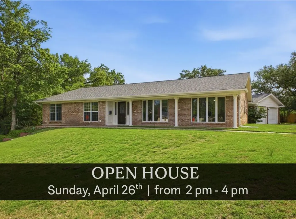 Brick ranch-style house with white columns and a black front door, set on a green lawn under a blue sky. Text overlay: "Open House, Sunday, April 26th, 2-4 pm."
