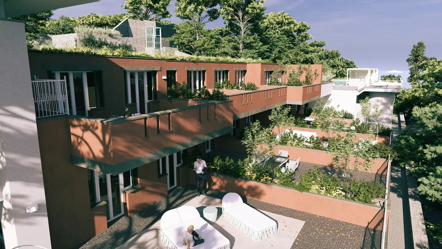 Exterior view of a multi-story terracotta building with green roofs and terraces, surrounded by lush trees. People are relaxing on white lounge chairs.