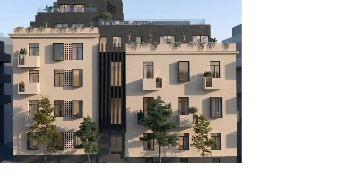 Exterior view of a beige apartment building with black accents, balconies, and trees in front.