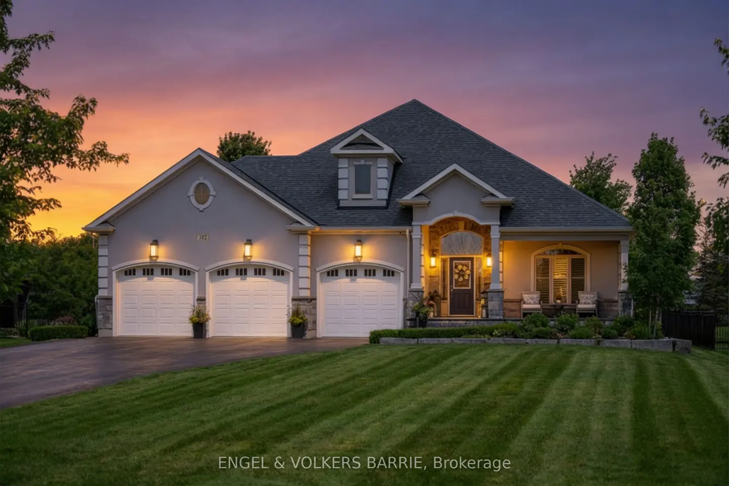 Beige single-story house with a dark roof, three-car garage, and manicured lawn at sunset.