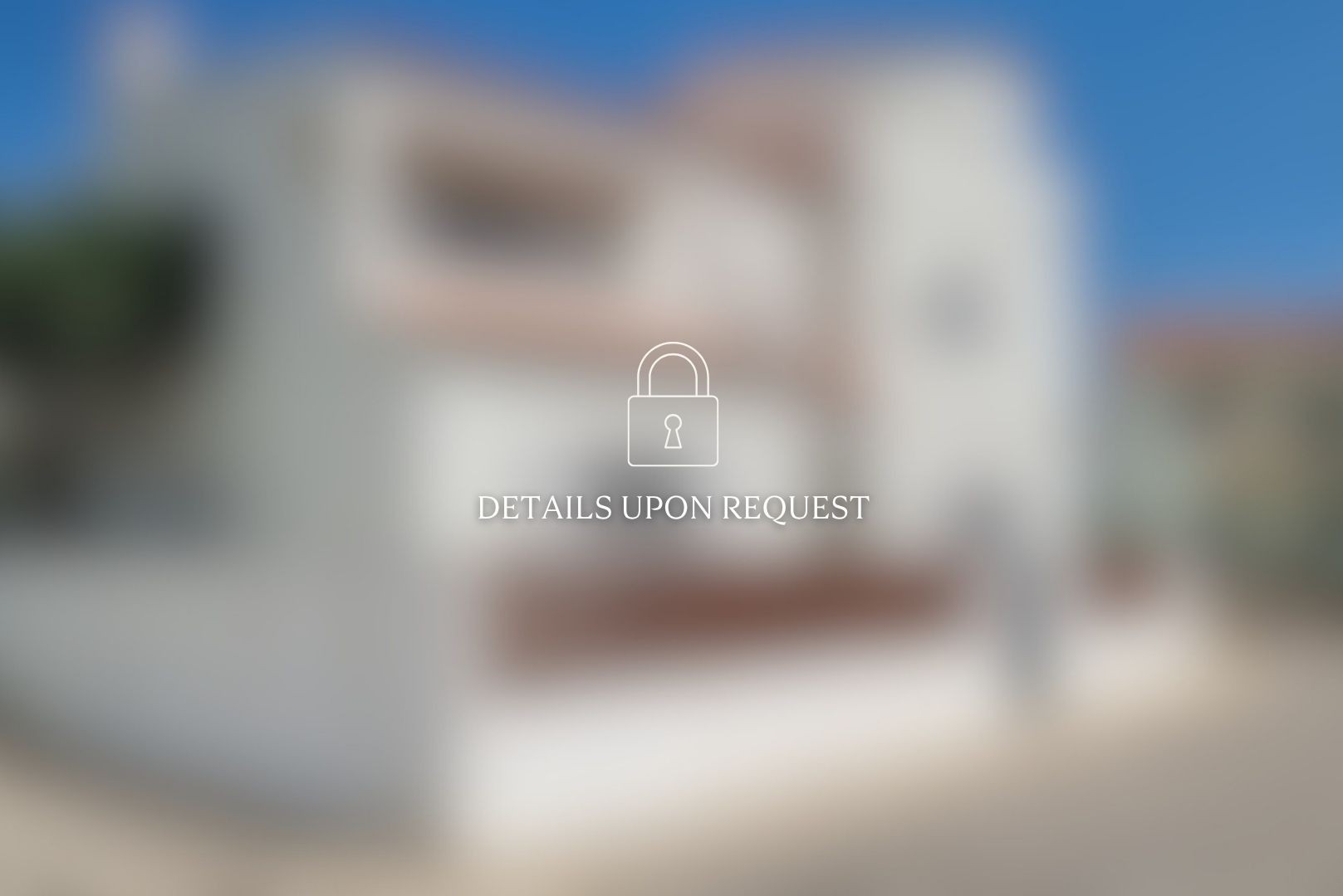 Blurred image of a two-story white house with a brown roof under a blue sky. A padlock icon and the text "DETAILS UPON REQUEST" are overlaid.