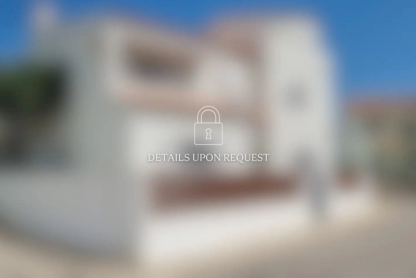 Blurred image of a two-story white house with a brown roof under a blue sky. A padlock icon and the text "DETAILS UPON REQUEST" are overlaid.