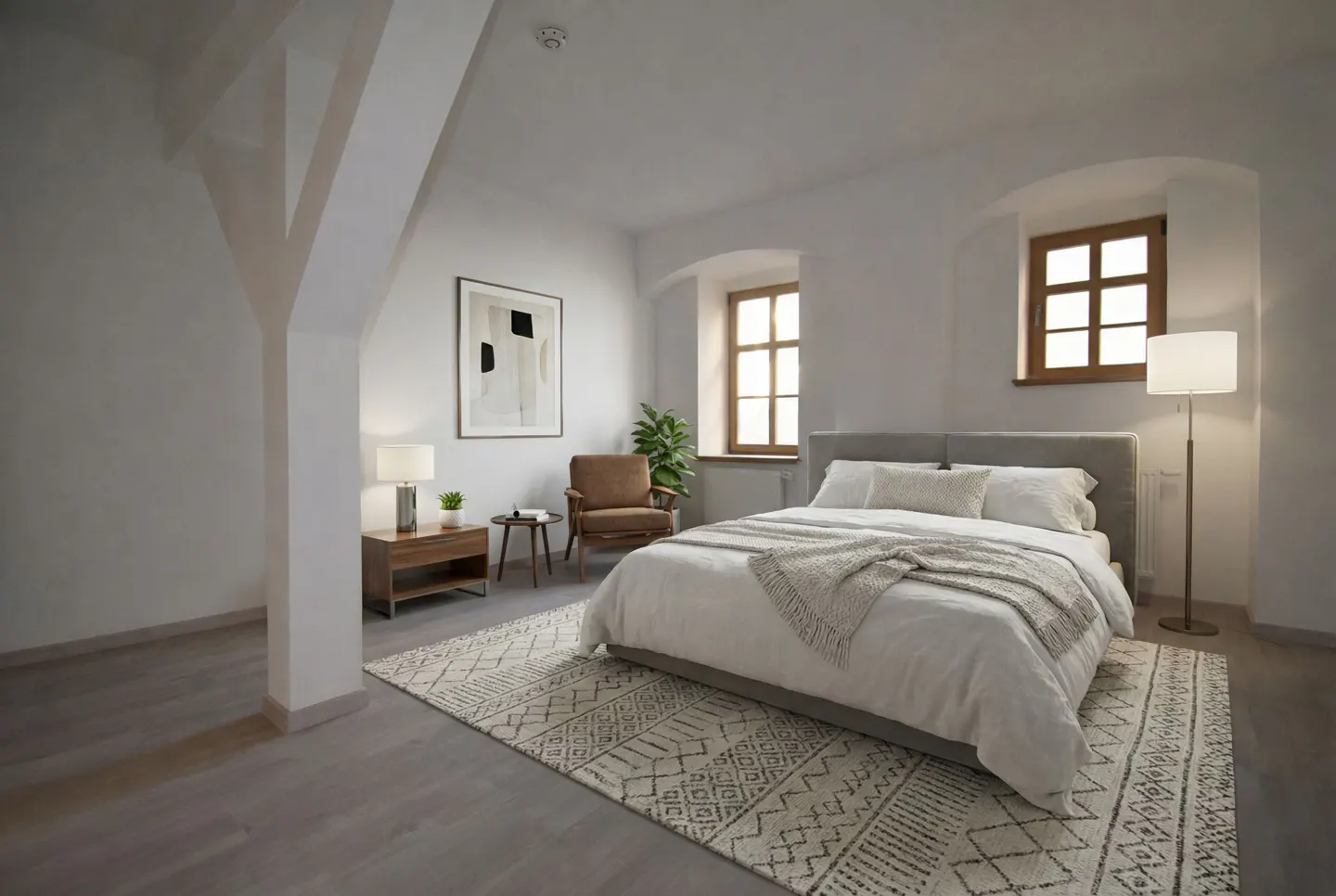 Bright bedroom with white walls, a gray bed, and a patterned rug. Windows with wood trim and a white support beam add architectural detail.