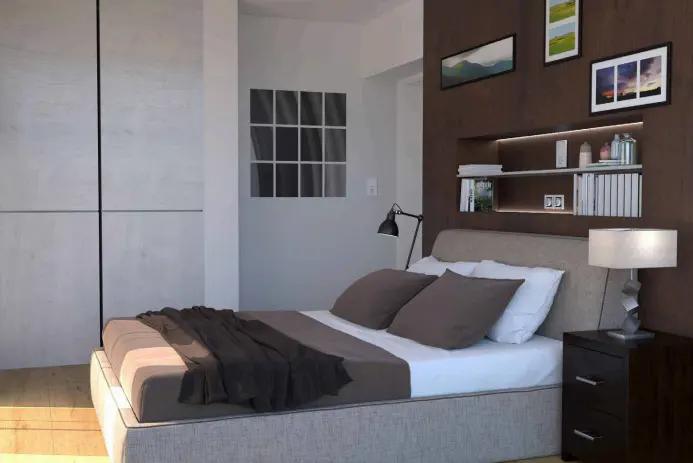 Bedroom with a bed, brown pillows, a black blanket, a black lamp, and a brown wall with shelves and pictures.