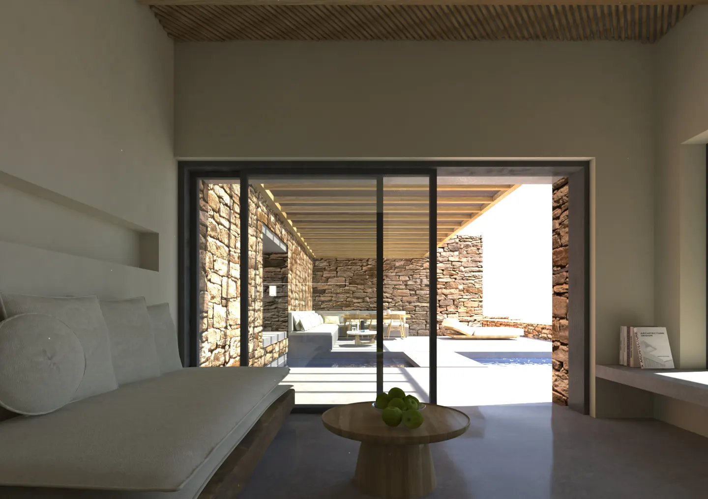 Interior view of a living room with a white sofa, a round table with green apples, and a stone patio visible through sliding glass doors.