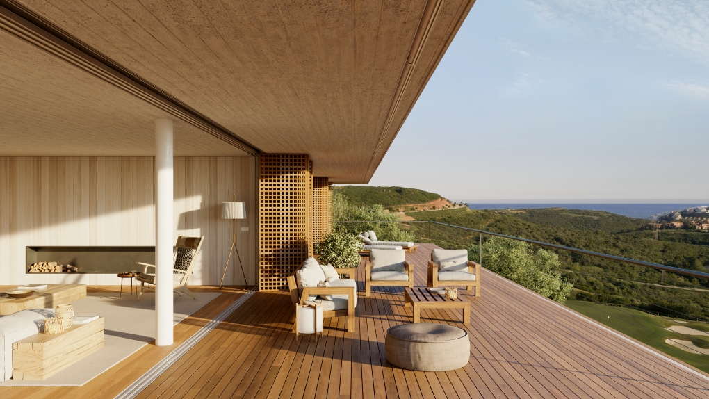 Modern terrace with wooden decking, outdoor seating, and a fireplace, overlooking a scenic landscape and the distant sea.