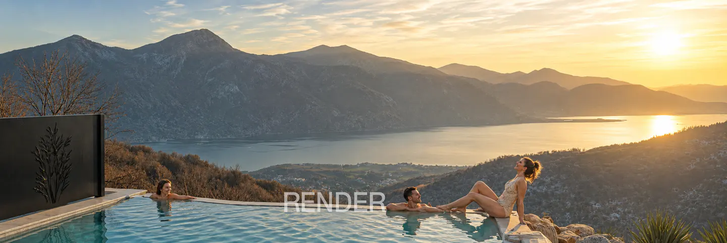 A couple relaxes in an infinity pool overlooking a scenic lake and mountains at sunset.