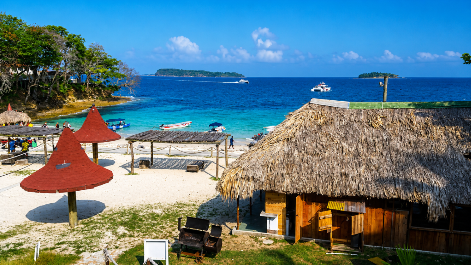 Beach scene with a thatched-roof building, red umbrellas, and turquoise water. Boats dot the horizon under a bright blue sky.
