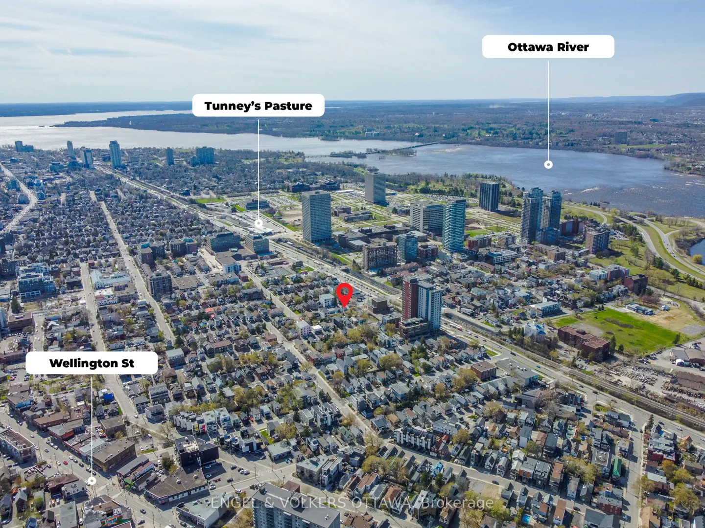 Aerial view of Ottawa, Canada, with the Ottawa River, Tunney's Pasture, and Wellington Street visible. A red marker highlights a property.