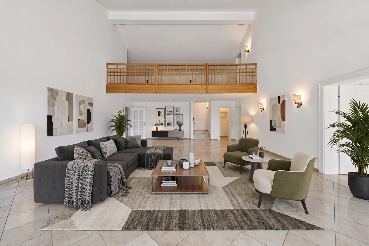 Bright, airy living room with a gray sectional sofa, olive green chairs, and a wooden balcony overlooking the space.