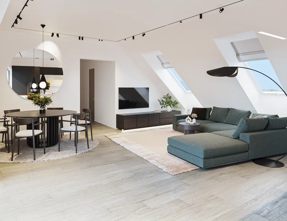 Bright, modern living room with a green sectional sofa, round dining table, and skylights. Track lighting illuminates the space.