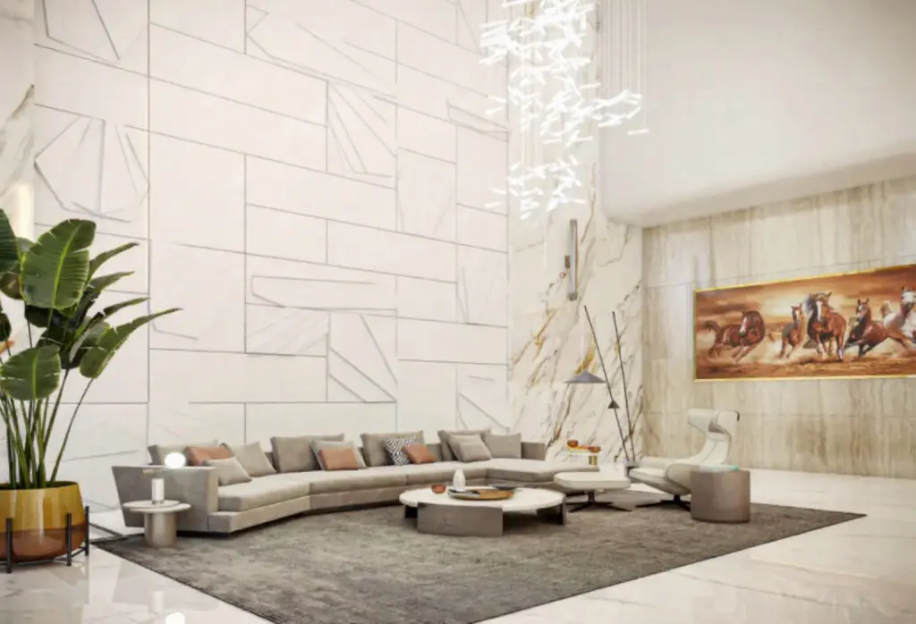 A modern living room with a gray sectional sofa, white walls, and a large painting of horses. A plant sits in the corner.