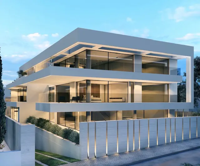 Modern three-story white house with large windows and balconies. A white fence with vertical lights surrounds the property.