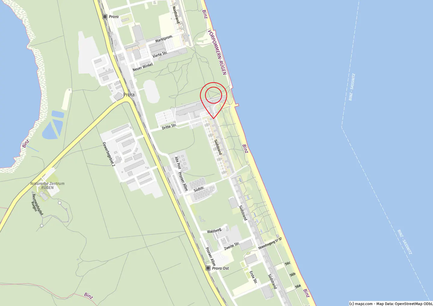 Map of Binz, Germany, showing streets, buildings, and the coastline. A red pin marks a location near the beach. The sea is light blue.