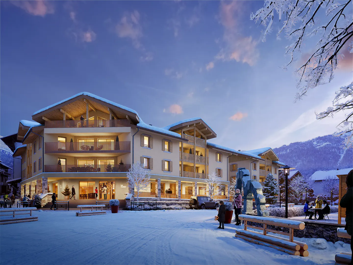 Exterior view of a multi-story beige building with balconies in a snowy, mountainous landscape. People are walking and sitting outside.