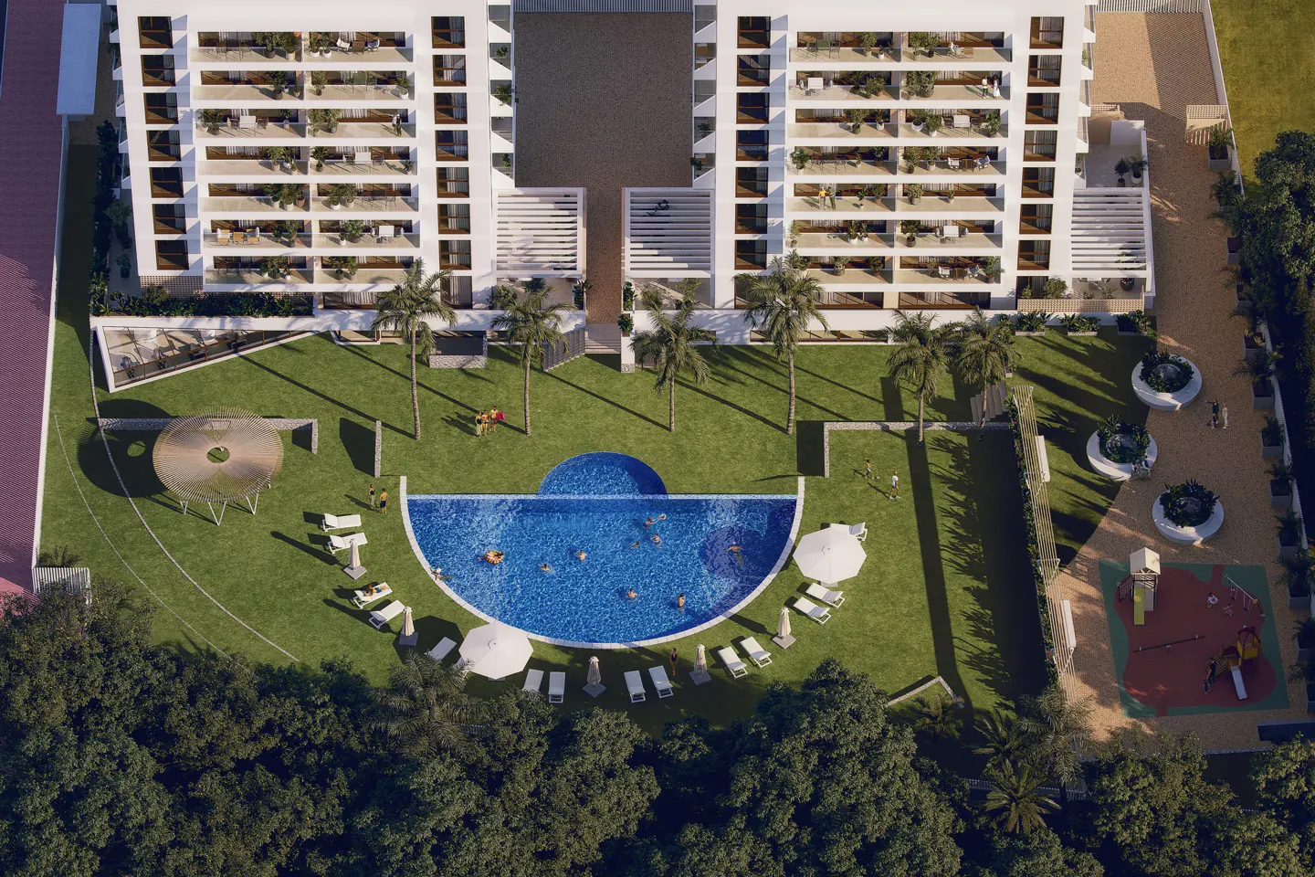 Aerial view of a white apartment building with balconies, a pool, green lawn, palm trees, and a playground.
