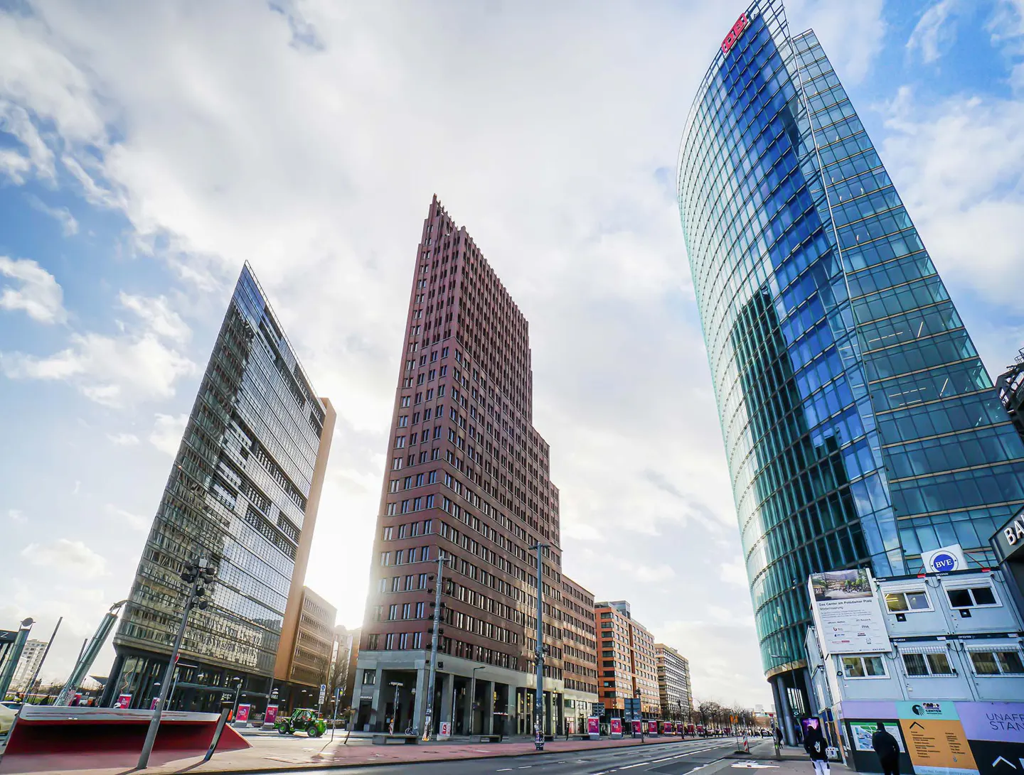 Cityscape view of Potsdamer Platz in Berlin, Germany, featuring modern skyscrapers against a cloudy sky.