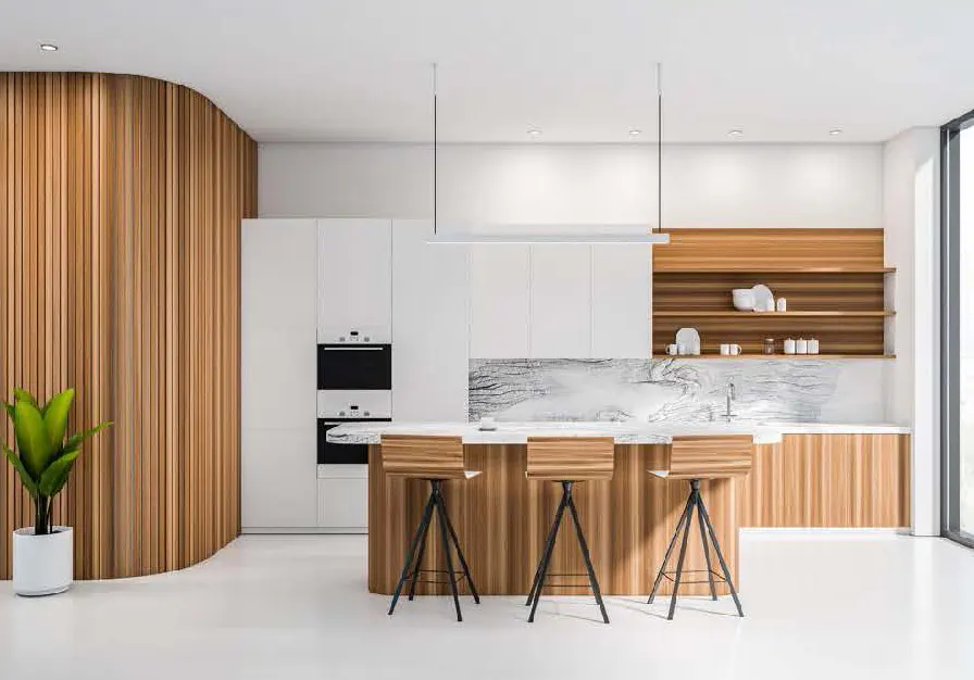 Bright, modern kitchen with white cabinets, wood accents, and a marble countertop island with three wooden stools. A potted plant sits near a curved wood wall.