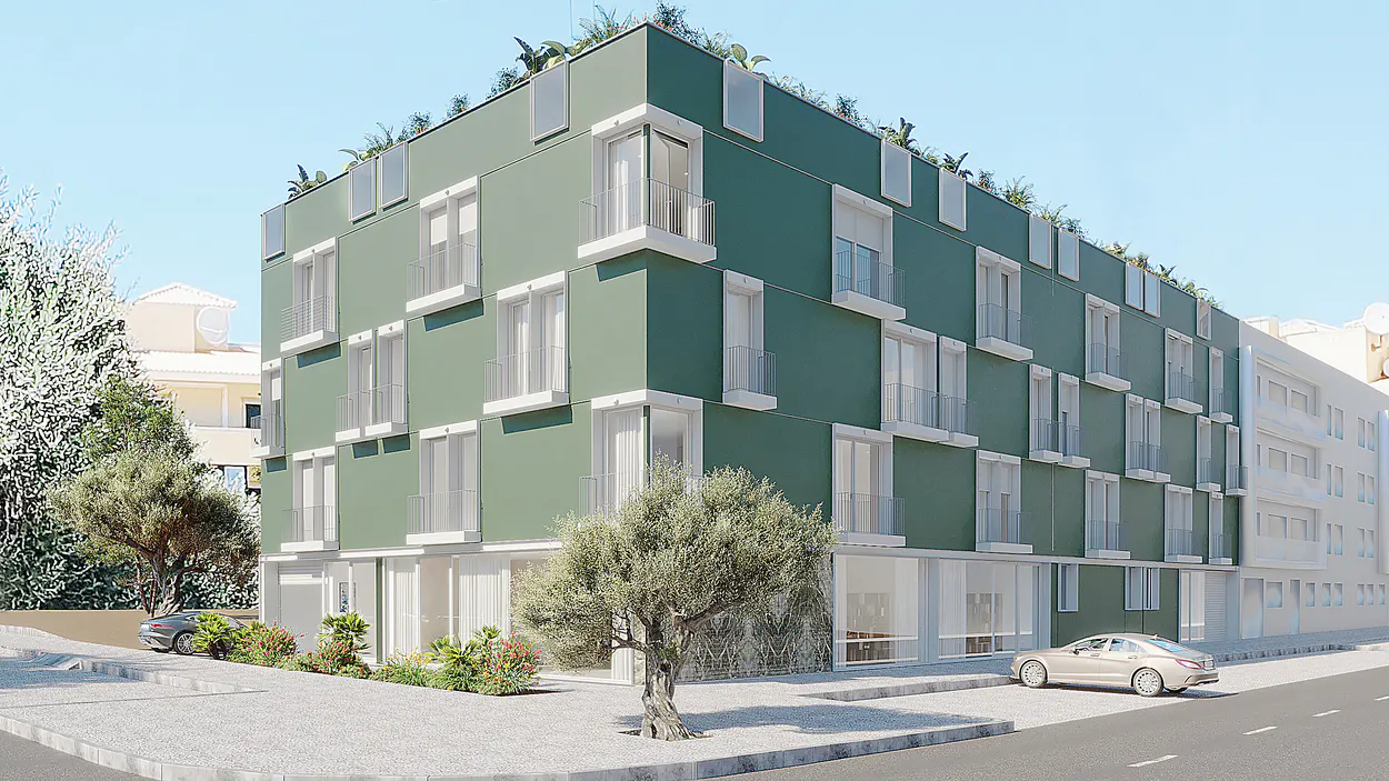 Modern green apartment building with white trim, balconies, and rooftop plants. Cars parked on the street.