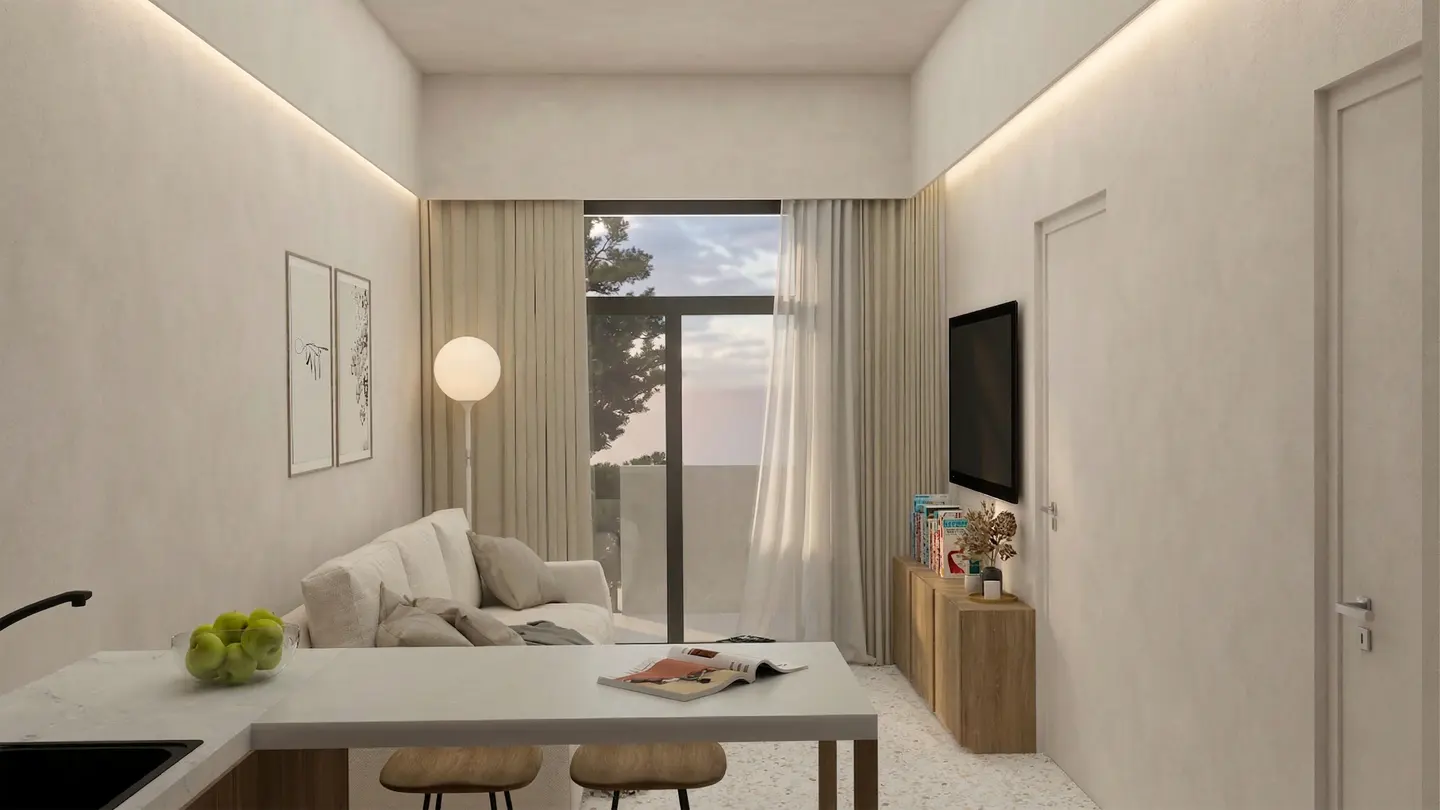 Bright, modern apartment interior with white walls, light wood cabinets, and a white sofa near a window with sheer curtains.