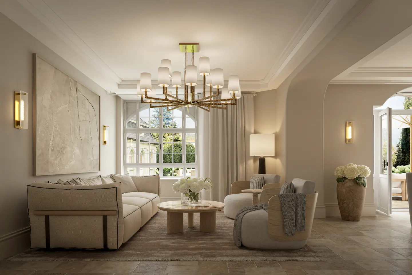 Elegant living room with cream sofa, two armchairs, round coffee table, large chandelier, and stone tile flooring.