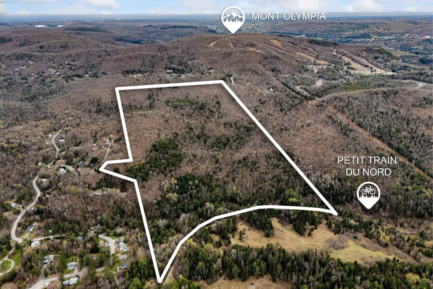Aerial view of a wooded lot outlined in white, near Mont Olympia and Petit Train du Nord.