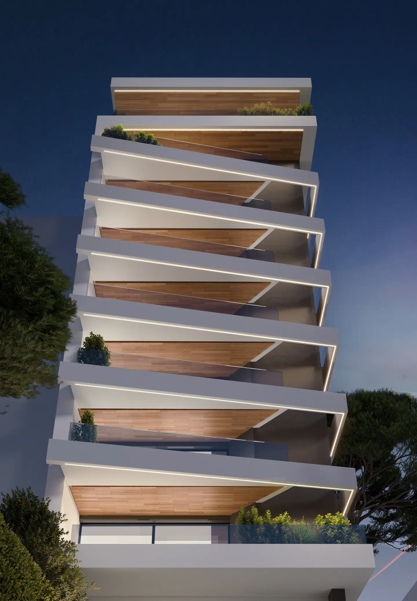 Modern white building with staggered balconies and wood ceilings at dusk.