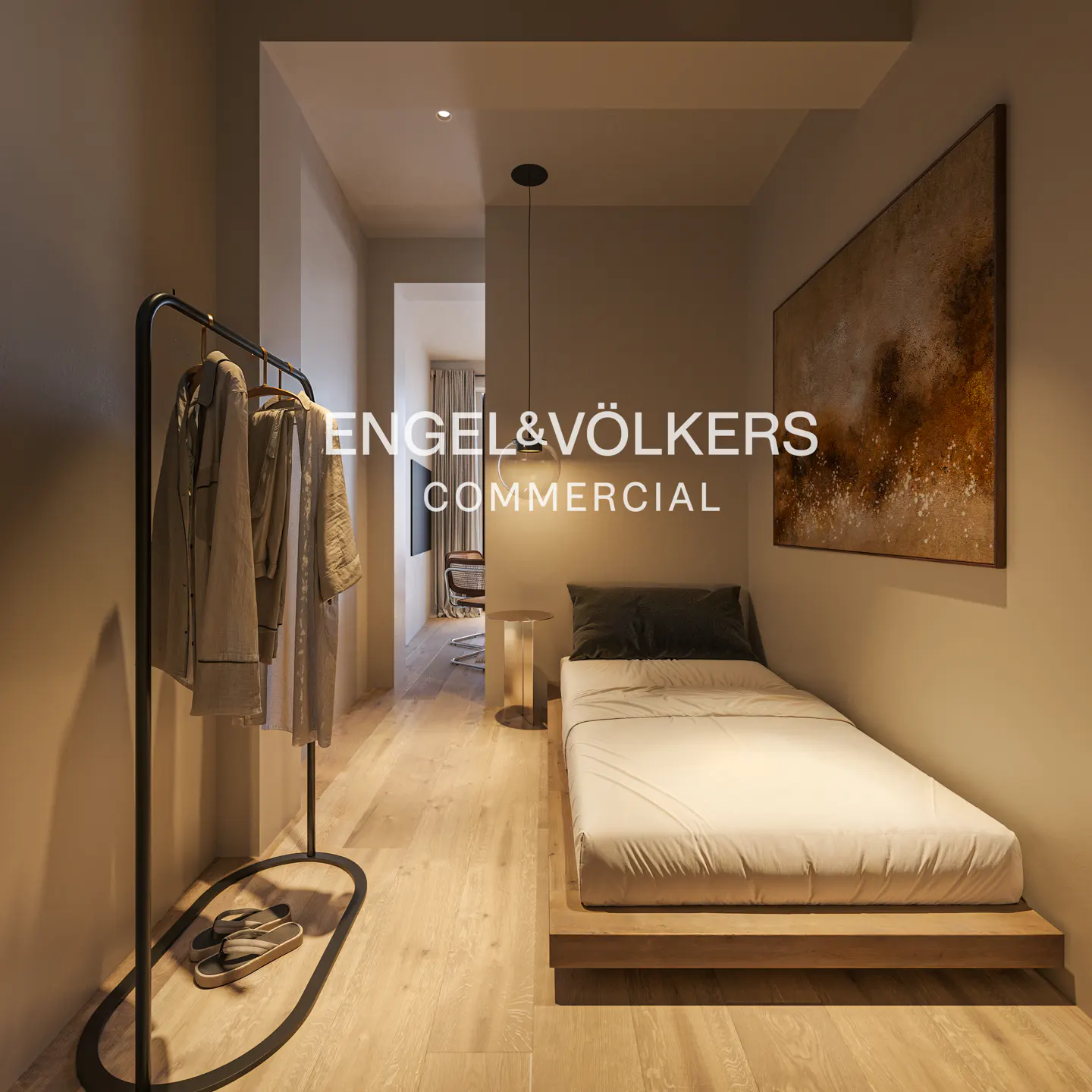 A modern bedroom with a single bed, wood floors, and a black clothing rack with pajamas. An abstract painting hangs on the wall.