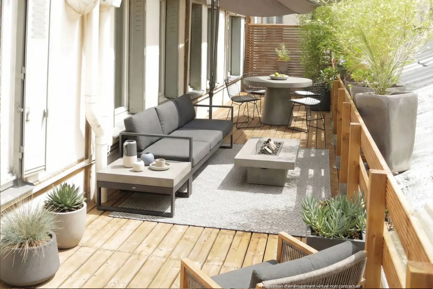 A wooden deck features a gray sofa, a concrete table with a fire pit, and a round table with chairs. Potted plants add greenery.
